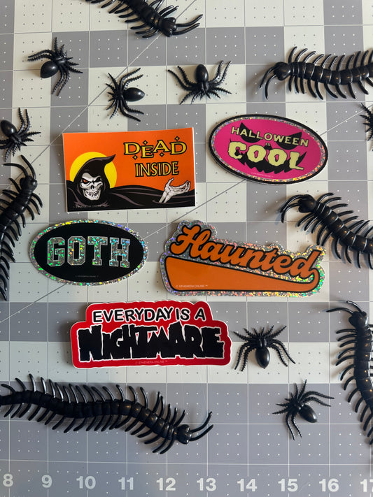 Halloween-themed stickers on a grid background with spiders.