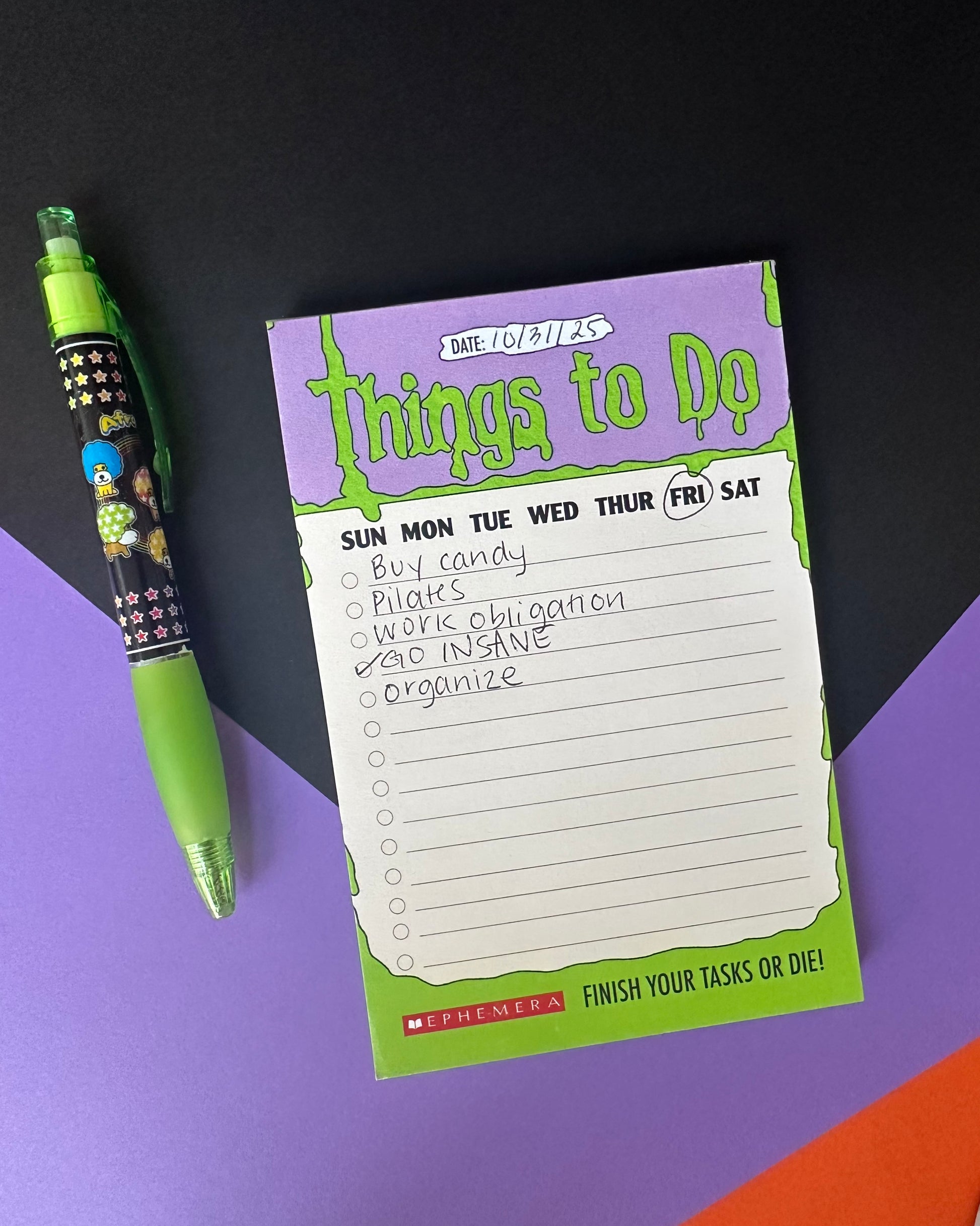 Notepad with 'Things to Do' list and a green pen on a colorful background that looks like a Goosebumps book
